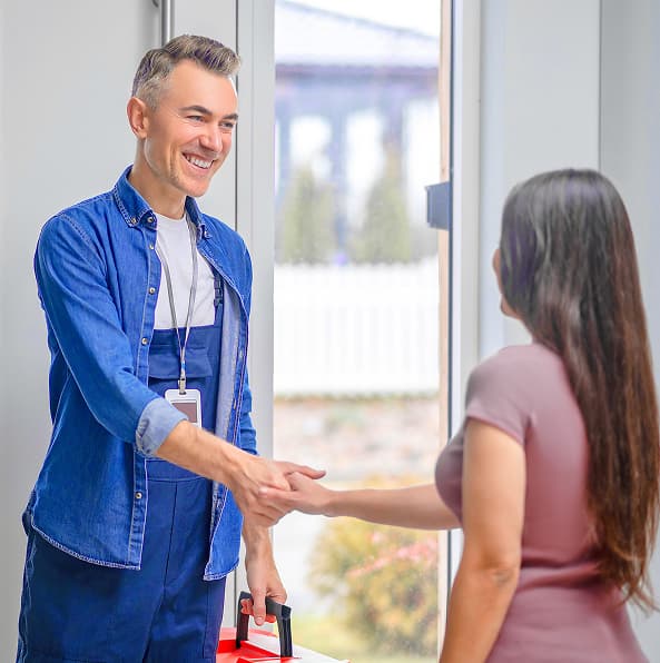 Plumber shaking hands with customer