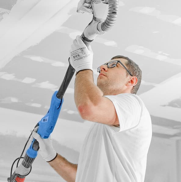 Plumber working on ceiling pipe